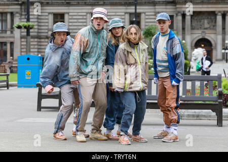 Glasgow, UK. 13 June 2019. Lunchtime crowds in Glasgow's George Square were treated to free dance show by the performers of 'WASTELAND' dance troupe, a high energy theatre marking the 25th anniversary of the demolition of Grimethorpe Colliery in South Yorkshire and 30 years since the rise of the UK rave culture. The Scottish premier is at Glasgow's Tramway theatre on 14th and 15th June. Credit: Findlay/Alamy Live News Stock Photo