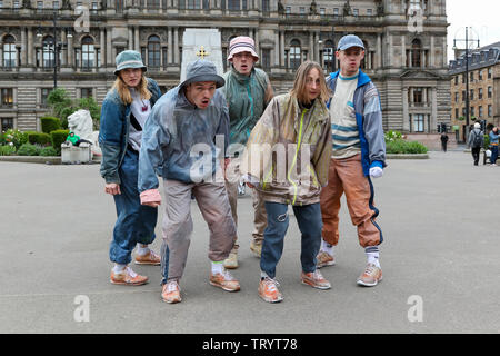 Glasgow, UK. 13 June 2019. Lunchtime crowds in Glasgow's George Square were treated to free dance show by the performers of "WASTELAND" dance troupe, a high energy theatre marking the 25th anniversary of the demolition of Grimethorpe Colliery in South Yorkshire and 30 years since the rise of the UK rave culture. The Scottish premier is at Glasgow's Tramway theatre on 14th and 15th June. Credit: Findlay/Ģ����ý Live News Stock Photo