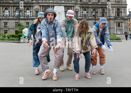 Glasgow, UK. 13 June 2019. Lunchtime crowds in Glasgow's George Square were treated to free dance show by the performers of 'WASTELAND' dance troupe, a high energy theatre marking the 25th anniversary of the demolition of Grimethorpe Colliery in South Yorkshire and 30 years since the rise of the UK rave culture. The Scottish premier is at Glasgow's Tramway theatre on 14th and 15th June. Credit: Findlay/Alamy Live News Stock Photo