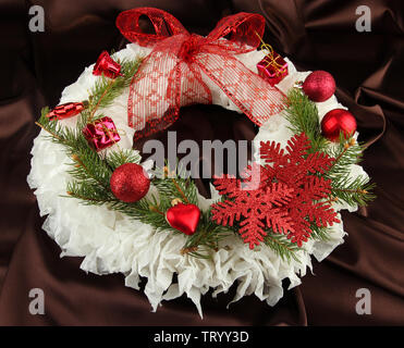 Christmas wreath on fabric background Stock Photo