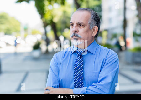 Fired and sad senior businessman outdoor in the city Stock Photo