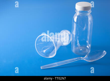 single use plastic bottles, cups, spoons. concept of recycling plastic, plastic waste Stock Photo