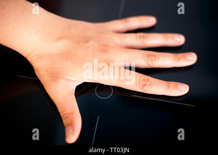 Woman palm on Induction hob. Close up. Stock Photo