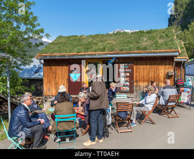 People sitting outside a cafe specialising in hot chocolate, Geiranger, Møre og Romsdal, Sunnmøre, Norway Stock Photo