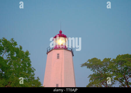 Lighthouse in Sandy Hook, New Jersey, at dusk, with the light turned on -08 Stock Photo