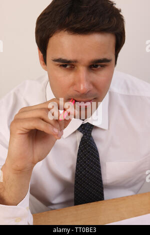 Businessman sitting at desk and brainstorming Stock Photo