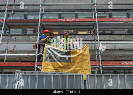 Belgrade, Serbia, June 6th 2019: Construction workers on the scaffold taking a break Stock Photo