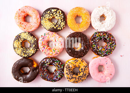 Overhead view of a dozen freshly baked doughnuts Stock Photo