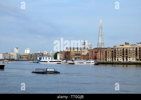 View of Shard skyscraper, Wapping city apartments, boats and barge on the River Thames view from Rotherhithe South London England UK KATHY DEWITT Stock Photo