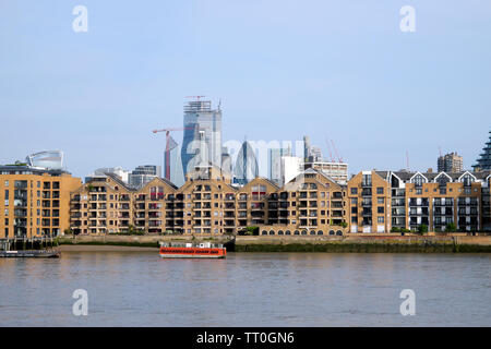 River Thames near Wapping riverside apartments with a cityscape skyline  view of the City of London skyscrapers London England UK    KATHY DEWITT Stock Photo