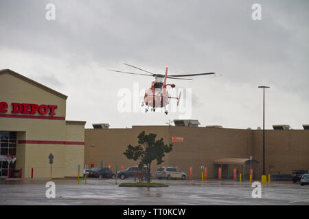 Coast Guard Helicopter landing in parking lot during rescue efforts in  Hurricane Harvey in Texas Stock Photo