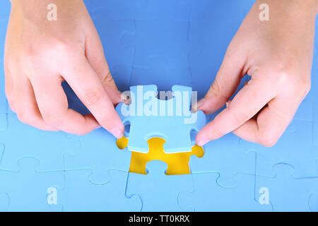 Hand holding puzzle piece, close up Stock Photo