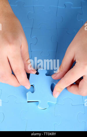 Hand holding puzzle piece, close up Stock Photo