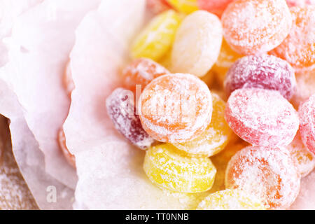Sweet  multicolor candies on paper, close up Stock Photo