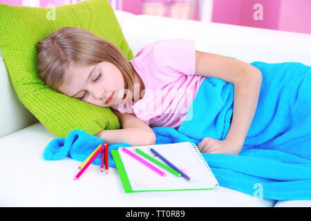 Little girl sleeping on sofa in room Stock Photo