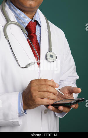 Mid section of a male doctor using a pda Stock Photo