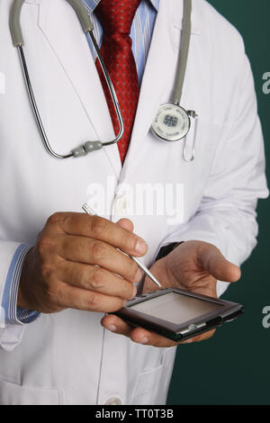 Mid section view of a male doctor using a pda Stock Photo