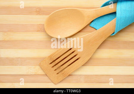 Wooden spatula and spoon isolated on the chopping board Stock Photo