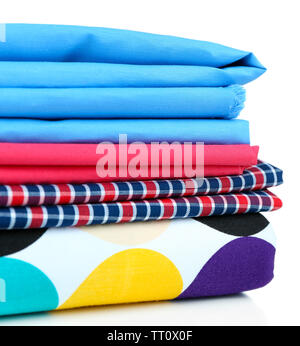 Pile of colored fabrics isolated on white Stock Photo