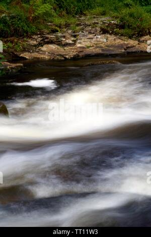 Rapids along the River Dart Flowing Through Hembury Woods on a Late Summers Afternoon. Buckfastleigh, Dartmoor, Devon, UK. Stock Photo