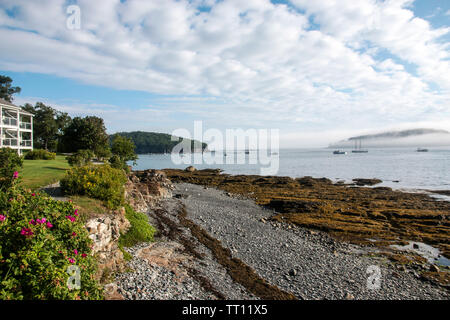 The view of Bar Harbors waterfront from the gravel running path along the shore in the early morning. Stock Photo