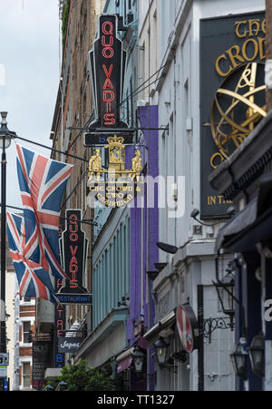 view along Dean Street featuring The Crown and Two Chairmen pub and Quo Vadis restaurant, Soho, London Stock Photo