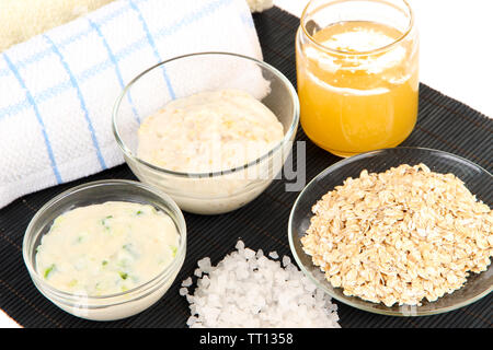 Homemade facial mask with oats and honey on bamboo mat, isolated on white Stock Photo