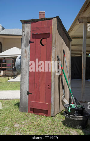Pioneer Days small town annual celebration in North Central Florida.  Wooden outhouse sits outside the historical museum, High Springs, FL. Stock Photo