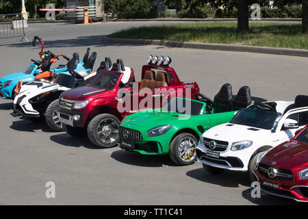 Moscow, RUSSIA - June 5, 2019 Multi-colored children's cars in the form of jeeps in a rental in the park Stock Photo