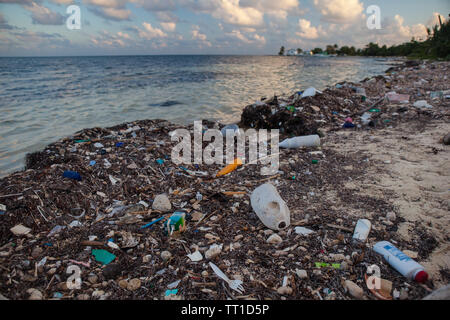 Plastic garbage has washed up on a remote beach in the Caribbean Sea off the coast of Belize. This area is part of the Mesoamerican Barrier Reef. Stock Photo