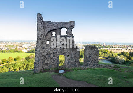 The ancient ruin (15th century) of Saint Anthony's Chapel in Holyrood Park, with the city of  Edinburgh in the background,Scotland Stock Photo