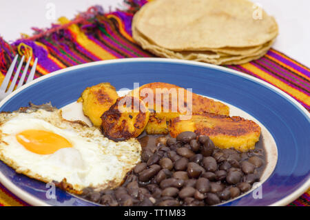 mexican tropical breakfast, made with plantains, eggs and black beans with tortillas, copy space Stock Photo