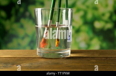 Brush with color paint in glass of water, isolated on white Stock Photo -  Alamy