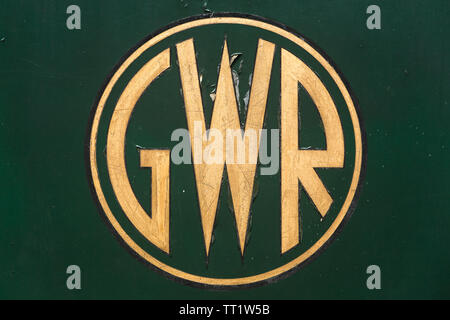 Great Western Railways circular/round GWR logo painted on side of old green steam train in gold and black paint at Didcot Railway Centre, Oxfordshire. Stock Photo