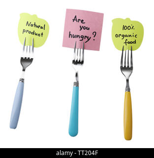 Note papers with messages  attached to forks, isolated on white Stock Photo