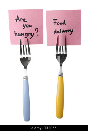 Note papers with messages  attached to forks, isolated on white Stock Photo