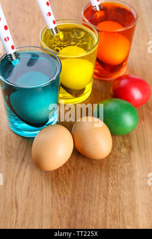 Glasses with paint for Easter eggs and eggs, close up Stock Photo