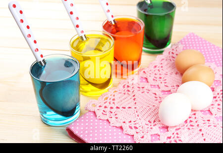 Glasses with paint for Easter eggs and eggs, close up Stock Photo