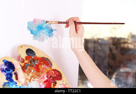 Paint palette with various acrylic paints and a brush Stock Photo