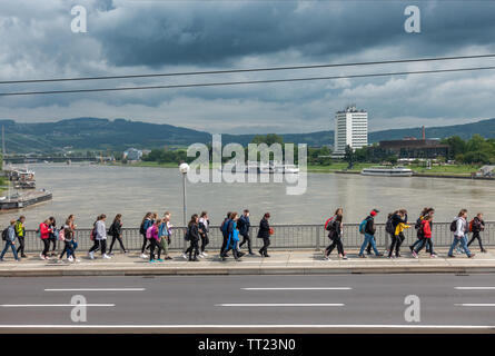 Linz Nibelungen Bridge across the river Danube with students, river cruise boats and Arcotel Nike. Nibelungenbrücke Linz Österreich Austria. Stock Photo