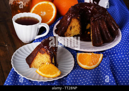 Piece of delicious cake  with oranges on table close-up Stock Photo