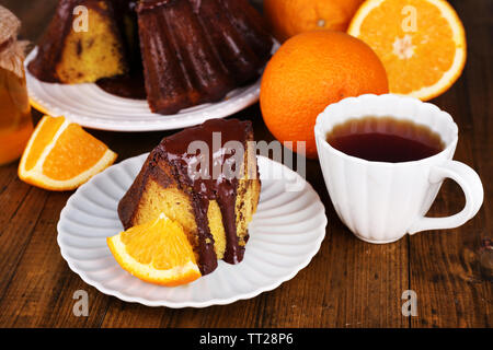 Piece of delicious cake  with oranges on table close-up Stock Photo