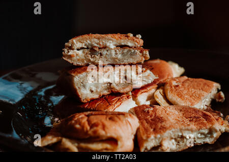 Close up of Malaysian well known food 'Roti John' on a dark background. John bread or 'Roti John' made of eggs, minced meat and bread. Stock Photo