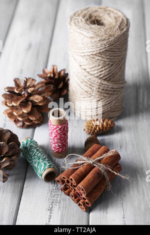 Composition with natural bump, thread, cinnamon sticks on wooden ...