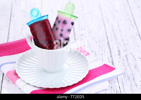 Fruit ice cream in cup on wooden table close-up Stock Photo