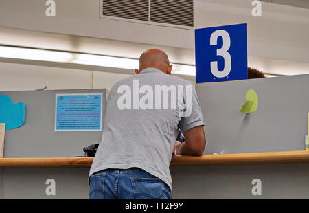 Wethersfield, CT / USA - June 11, 2019: A man consults a customer service agent at the third booth Stock Photo