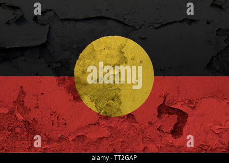 Australian Aboriginal flag painted on the cracked grunge concrete wall Stock Photo