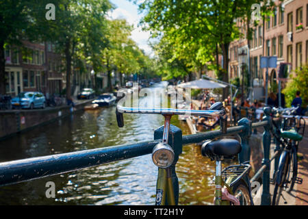 Close Up View of a Classic Old Bicycle on a Small Bridge, Amsterdam, Netherlands Stock Photo