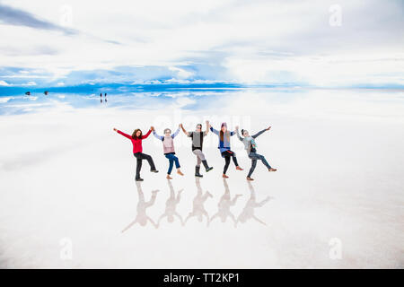 Uyuni, Bolivia- Dec 31, 2018: Group of people make Folk Dance at the lake Salar de Uyuni, Bolivia. America Stock Photo