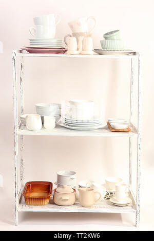 Different tableware on shelf, isolated on white Stock Photo - Alamy